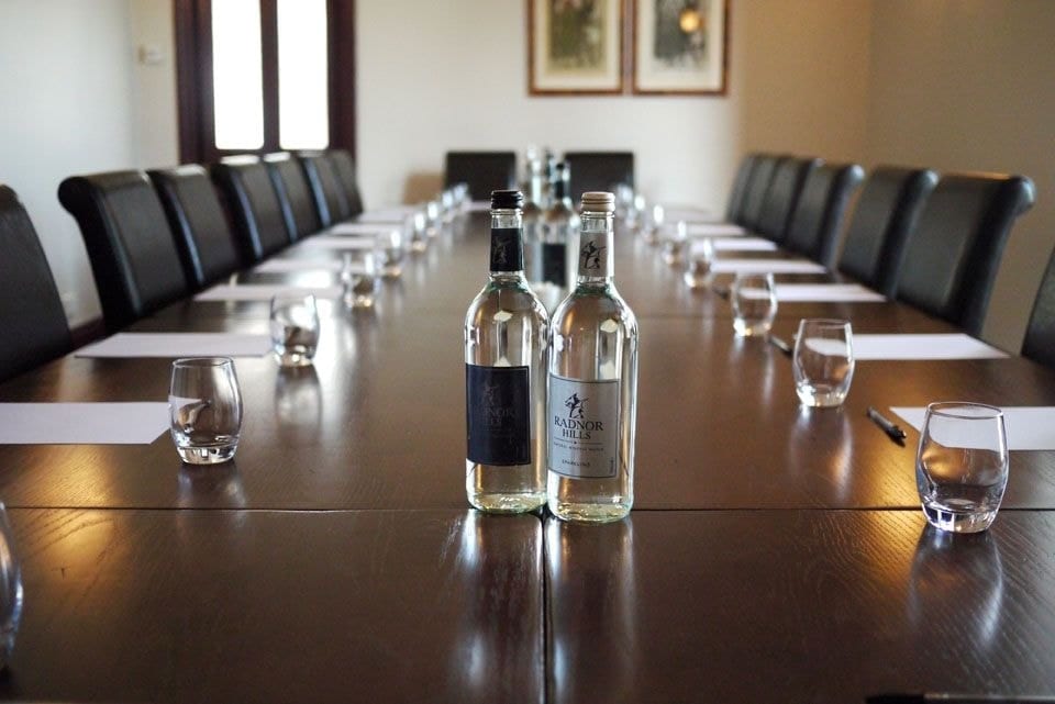 Dining table set for a formal dinner at Glewstone Court with wine